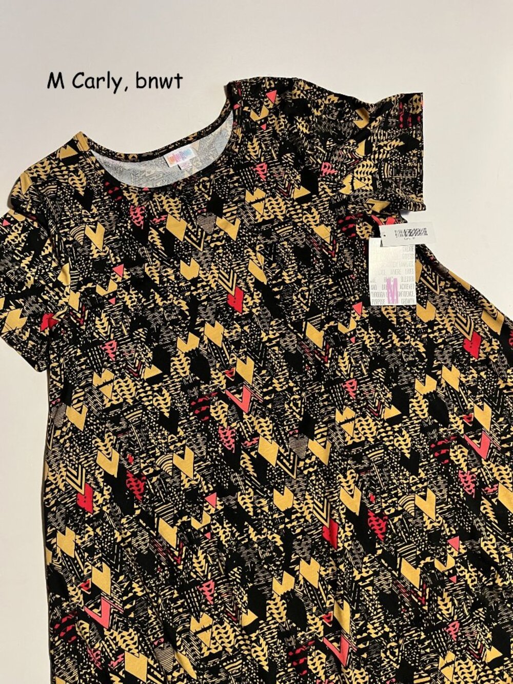 Medium Lularoe Carly hi-low dress, black and gold triangles, red touches